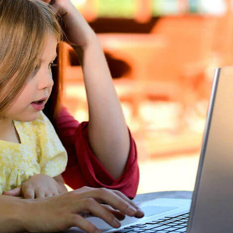 Child playing in laptop