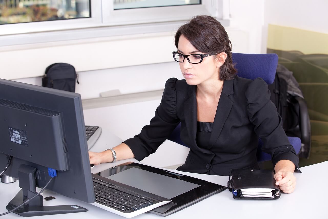 business woman performing a data back up on her computer